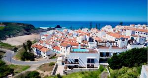 a village with white houses and a beach at Zambujeira Terrace in Zambujeira do Mar
