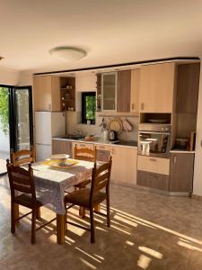 a kitchen with a table and some chairs and a table and a kitchen at Tomasova kuća in Križevci +22 photos
