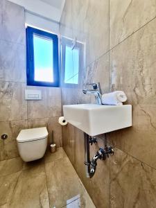 a bathroom with a sink and a toilet at Apartments Sunflower in Dramalj +14 photos