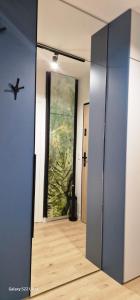 an open door to a hallway with a painting on the wall at Magic House Apartament Proszowska 58 II in Bochnia