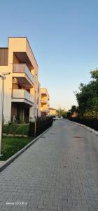 an empty street in front of a building at Magic House Apartament Proszowska 58 II in Bochnia +11 photos