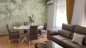 a living room with a couch and a table at Casa Rural Las Camelias in Herrera del Duque