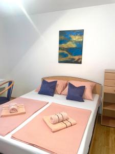 a bedroom with a bed with two towels on it at MFS Apartments in Mostar