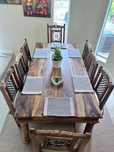 a wooden table with chairs and a potted plant on it at Near London Private House FortView Ancient Roman Trail in Gravesend