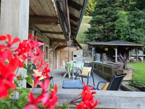 a porch of a house with a table and chairs at Traditional Chalet with some luxurious features in Troistorrents