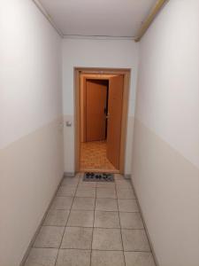 an empty hallway with a door and a tile floor at Apartma Kaj in Kaja in Maribor