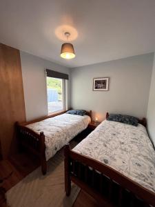 sypialnia z 2 łóżkami i oknem w obiekcie Spectacular Ocean Views in Tranquil and Private Location w mieście Dooagh