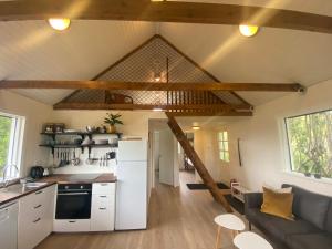 a kitchen and living room in a tiny house at Vallakot Farm Guesthouse in Laugar