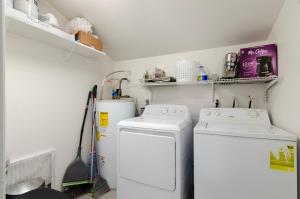 a small laundry room with a washer and dryer at Modern 2BR Getaway 15mn Phx. Intl Airport in Phoenix
