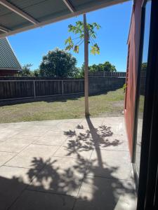 a shadow of a palm tree on a sidewalk at Auae hills lodge in Faaa