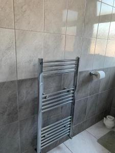 a shower with a glass door in a bathroom at Your Perfect HomeStay in Ilford