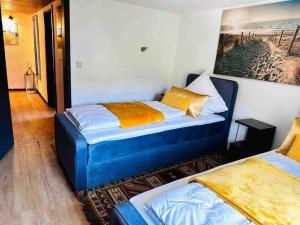 ein Schlafzimmer mit 2 Betten und einem Wandgemälde in der Unterkunft Amina’s Auberge nähe Saarbrücken in Alsting