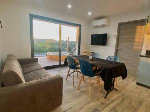 a living room with a table and a couch at Nid douillet et moderne in Beauménil