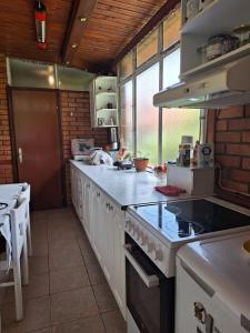 a kitchen with a stove and a counter top at Villa Ella in Ohrid
