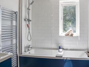 a bathroom with a shower and a sink and a tub at The Annexe The Roost in Godshill
