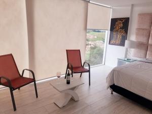 Postel nebo postele na pokoji v ubytování Mirador samsara Suite Luxury piso completo