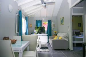 LES NUITS GALANTES MANDEVILLA MAISON PRIVÉE AVEC JACUZZI في سانت فرانسوا: غرفة معيشة بها أريكة وطاولة