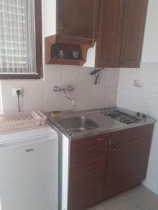 a small kitchen with a sink and a stove at Gala in Punat