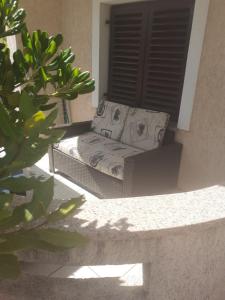 a couch sitting on the porch of a house at Gala in Punat