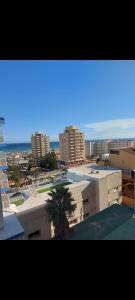 uitzicht op een stad met gebouwen en de oceaan bij Apartamento Florido in Torremolinos