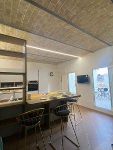 a kitchen with a table and chairs in a room at Ai Campanili in San Severo