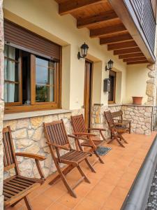 a row of chairs sitting on a patio at CASA LUISA Biedes, Piloña in Infiesto