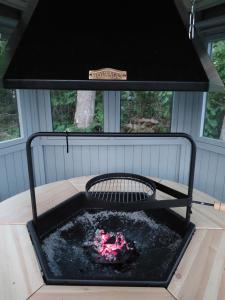 a fire pit in the middle of a house at Villa Verde in Kihelkonna