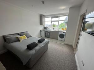 a bedroom with a bed with two pillows on it at Sunny Modern, 1 Bed Flat, 15 Mins Away From Central London in Hendon