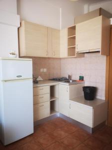 a kitchen with white appliances and a white refrigerator at El Verde Apartments in Skala