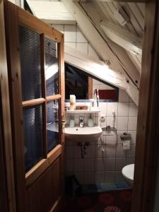 a small bathroom with a sink and a toilet at Maisonette-Appartment in historischem Ambiente in Iphofen
