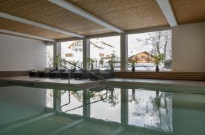 una piscina con vista su una casa di Hotel des Alpes a Flims