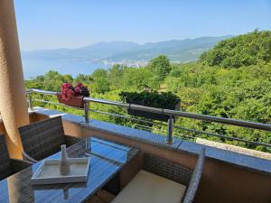a balcony with a table and a view of the water at Magic Eden Rijeka in Rijeka