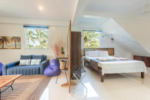 a bedroom with a bed and a couch at Kalipay Resort Siargao in General Luna +26 photos
