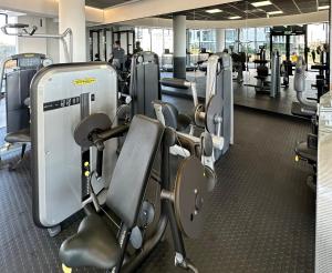 a gym with rows of cardio equipment in a building at Explore Emerald Studio - Ellipse Waterfall in Johannesburg