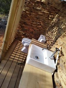 a white sink sitting on top of a wooden deck at Herdade da Maceira in São Luis