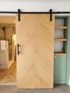 a sliding barn door in a room with a closet at Shepherd’s Run in South Kingstown