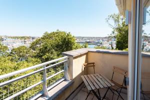a balcony with a bench and a view of the water at Harbour House in Plymouth