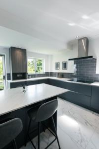 a kitchen with a table and two chairs in it at Harbour House in Plymouth