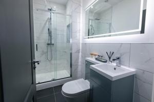 a white bathroom with a sink and a shower at Harbour House in Plymouth +23 photos