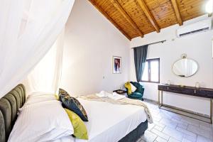a bedroom with two beds and a window at Via Porta Raimonda (Luxury central detached house) in Corfu Town