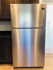 a stainless steel refrigerator sitting in a kitchen at Riverside Cabin 1 in Grants Pass