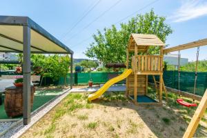 a backyard with a playground with a slide at Apartment Branko in Lopar