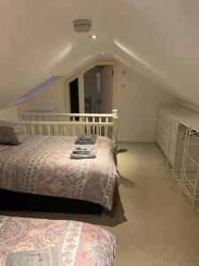 a bedroom with two beds and a mirror in it at The White House! Beautiful 4 Bed 3 Bath Sleeps 11 in St. Albans