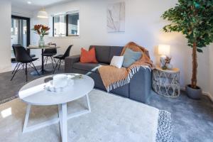 a living room with a couch and a table at Beautiful Gem by Hagley Park, Central City Chch in Christchurch