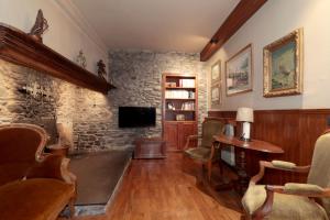 a living room with a stone wall at Casa Passeg dera Libertat 8 in Vielha