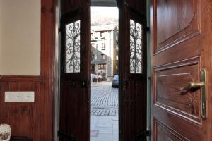 an open wooden door with a view of a street at Casa Passeg dera Libertat 8 in Vielha