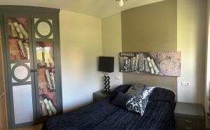 a bedroom with a bed and a book shelf at La Casa de Blanca in Candás