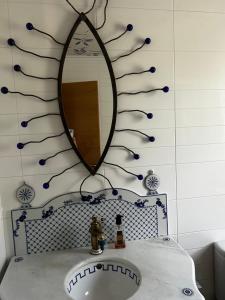 a bathroom with a mirror and a sink at La Casa de Blanca in Candás +46 photos