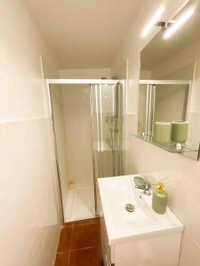 a white bathroom with a shower and a sink at Beautiful Apartment near Carcavelos Beach in Parede