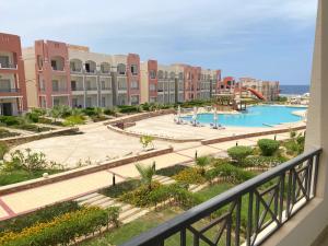 a view of a pool from the balcony of a resort at Oyster Bay Marsa Alam (unit I6-13) in Abu Dabbab